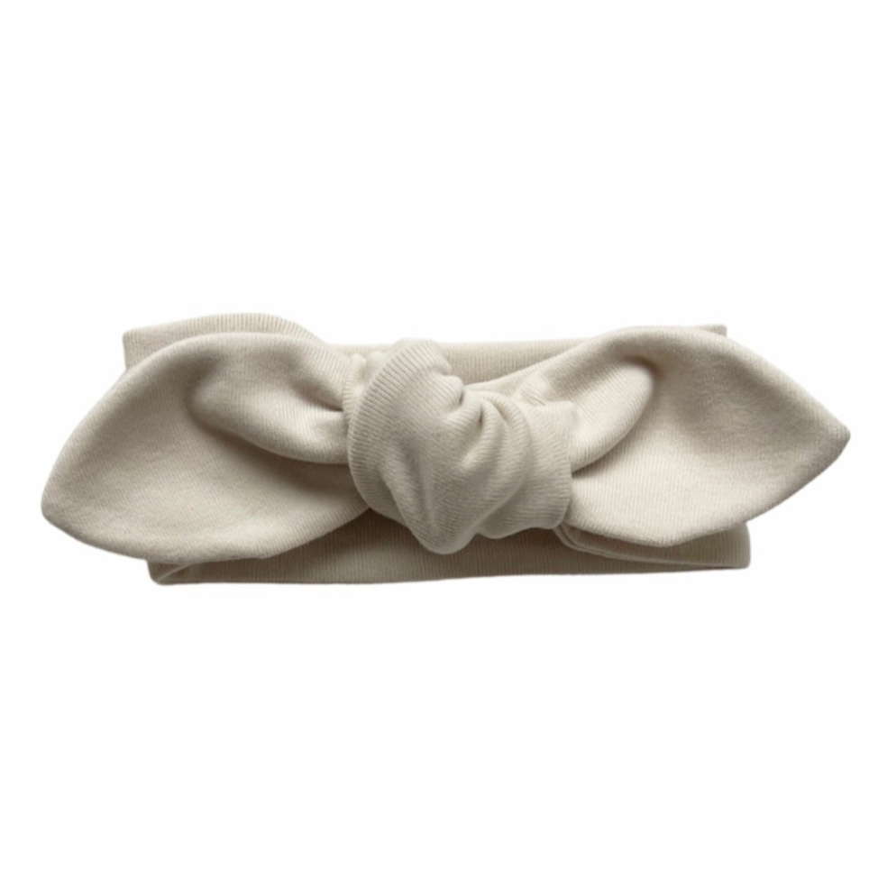 Beige headband with a knot on a white background